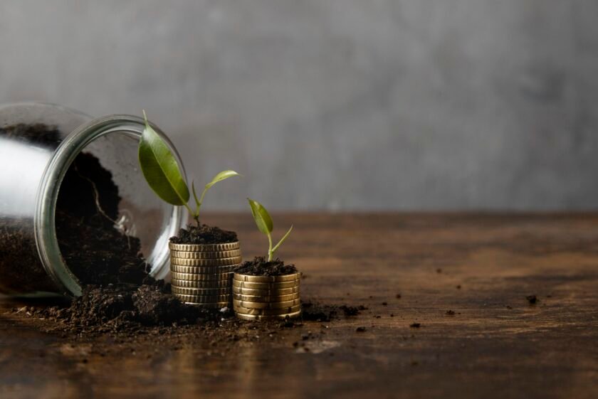 jar-with-dirt-stacked-coins-with-copy-space